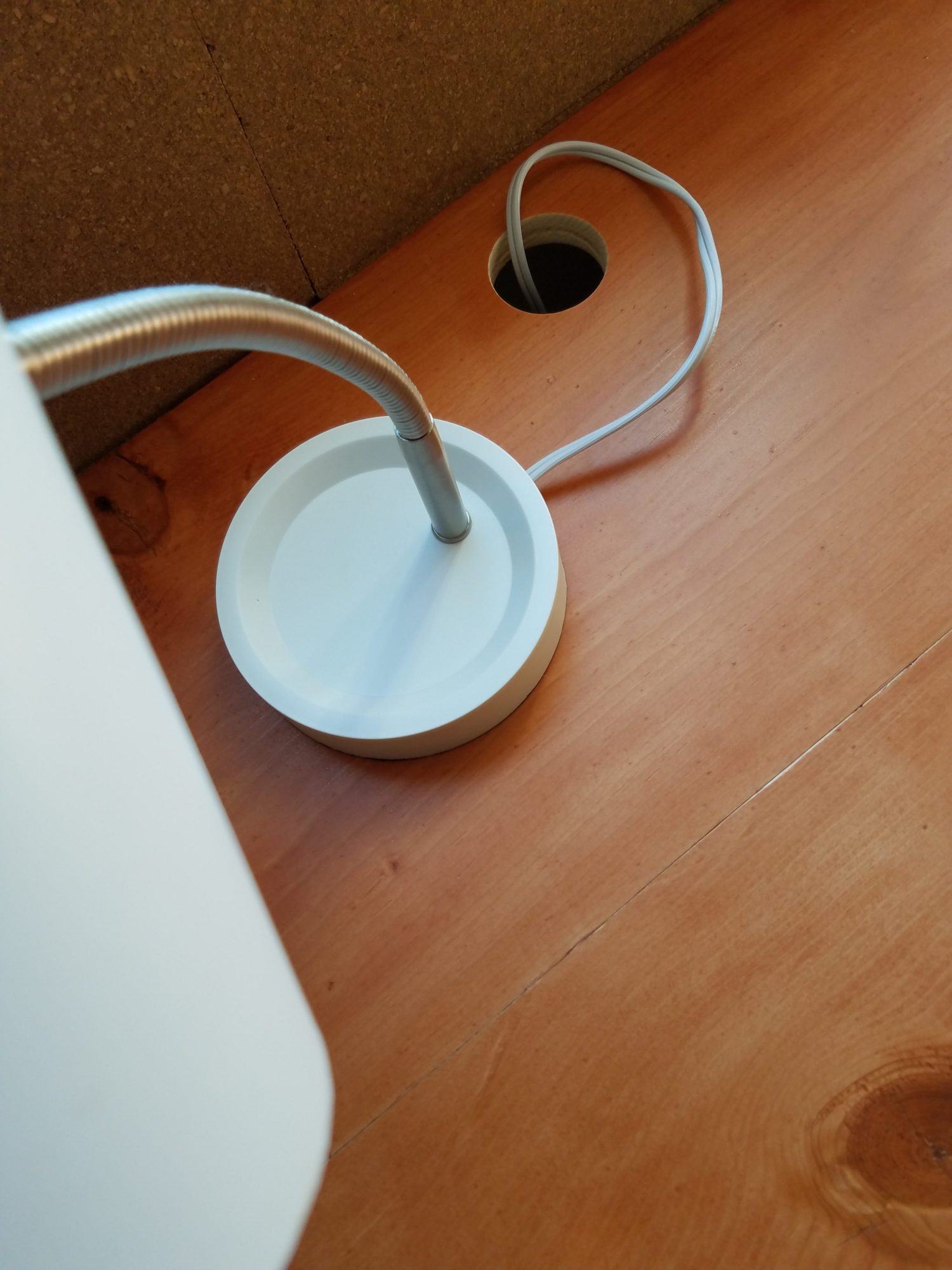 Holes drilled into the desk allow cords to pass.